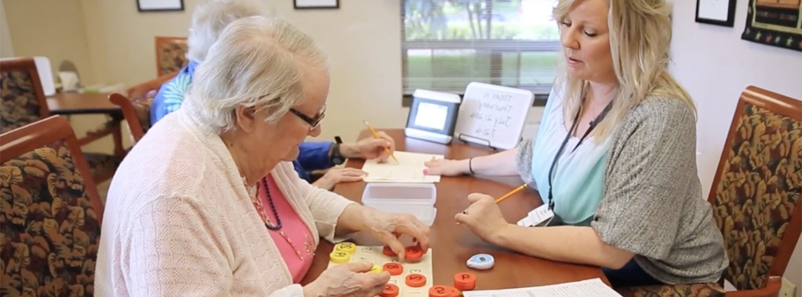 A memory care therapist working with two elderly patients